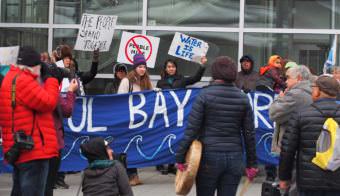 Groups rally against mine development near Dena'ina Convention Center during the Alaska Federation of Natives convention in Anchorage. Southeast and Bristol Bay tribal officials signed an agreement during the convention to combine fisheries-protection efforts. (Photo by Zach Hughes/Alaska Public Media)