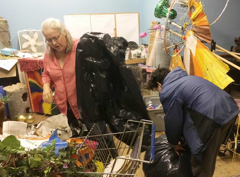 Ketchikan artist Halli Kenoyerleft, uses recycled trash to build a set piece for a community theater production. Ketchikan issues permits for locals who want to salvage metal, bowling balls and whatever else they find at the landfill. (Photo by Leila Kheiry/KRBD)