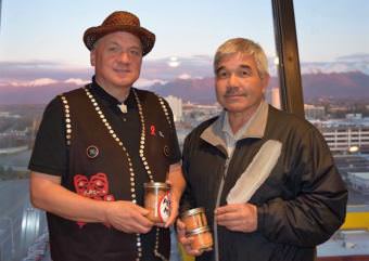 Southeast Alaska Indigenous Transboundary Commission Chairman Frederick Olsen Jr., left, and United Tribes of Bristol Bay President Robert Heyano hold canned salmon after signing an agreement Oct. 18. (Photo by  United Tribes of Bristol Bay)