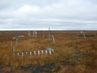 As the permafrost thaws, Kongiganak's cemetery is turning into swampland. Community members are now laying their loved ones to rest on raised platforms above ground. (Photo Teresa Cotsirilos/KYUK)