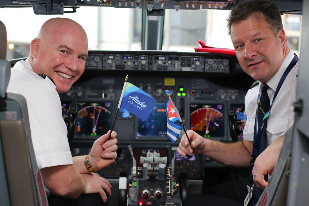 Pilots waved flags in the cockpit before taking off on Alaska Airlines' inaugural flight to Havana, Cuba on January 5, 2017. (Photo courtesy Alaska Airlines)