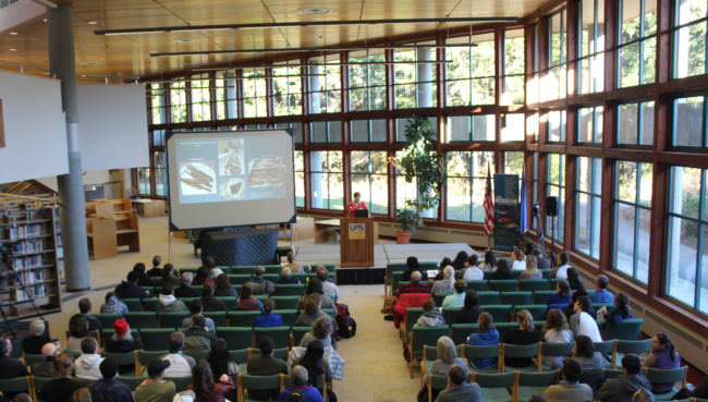 Forest Haven, a Ph.D. candidate in cultural anthropology at U.C. Irvine from Metlakatla, gives a keynote address at the second annual Power &amp; Privilege Symposium at the University of Alaska Southeast. (Photo by Adelyn Baxter/KTOO)