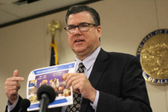 Alaska Gasline Development Ccorporation president Keith Meyer points at a press pamphlet emphasizing the China-Alaska partnership to study Alaska's LNG pipeline project on Tuesday, November 21, 2017, in Anchorage, Alaska. (Photo by Wesley Early, Alaska Public Media - Anchorage)