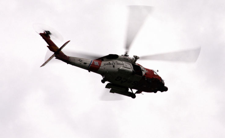 A Coast Guard H-60 helicopter flies over the Douglas Bridge on Wednesday, Dec. 6, 2017, during a search for two men who went missing after a skiff capsized on the night before near Aurora Harbor. (Photo by Tripp J Crouse/KTOO)