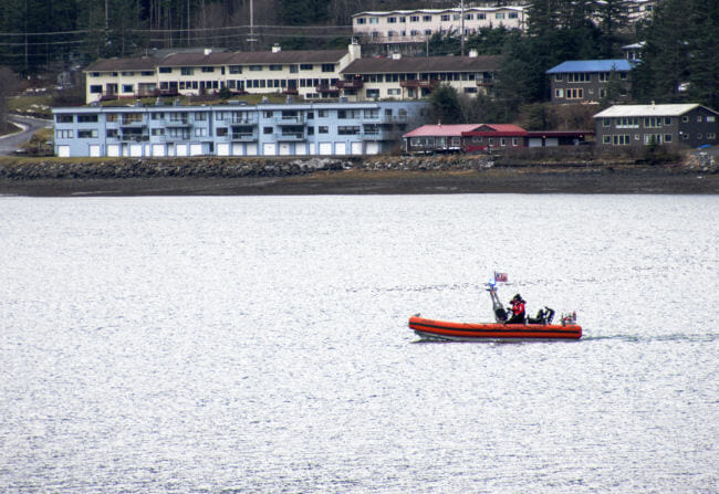 The Coast Guard searches Gastineau Channel on Wednesday, Dec. 6, 2017, for two men who went missing after a boat capsized the night before near Aurora Harbor. (Photo by Tripp J Crouse/KTOO)