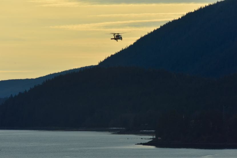 A Coast Guard Air Station Sitka MH-60 Jayhawk helicopter crew searches Gastineau Channel in Juneau on Dec. 6, 2017. Two men remain unaccounted for after their skiff capsized the night before.