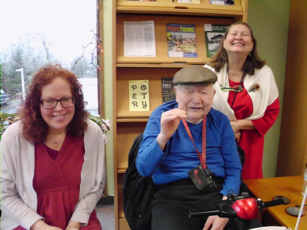 Victoria McKoy, left, John Russell Reese and Terri Burr pose during McCoy’s capstone presentation on Nov. 30 at the University of Alaska Southeast Ketchikan Campus Library. (Photo by Maria Dudzak/KRBD)