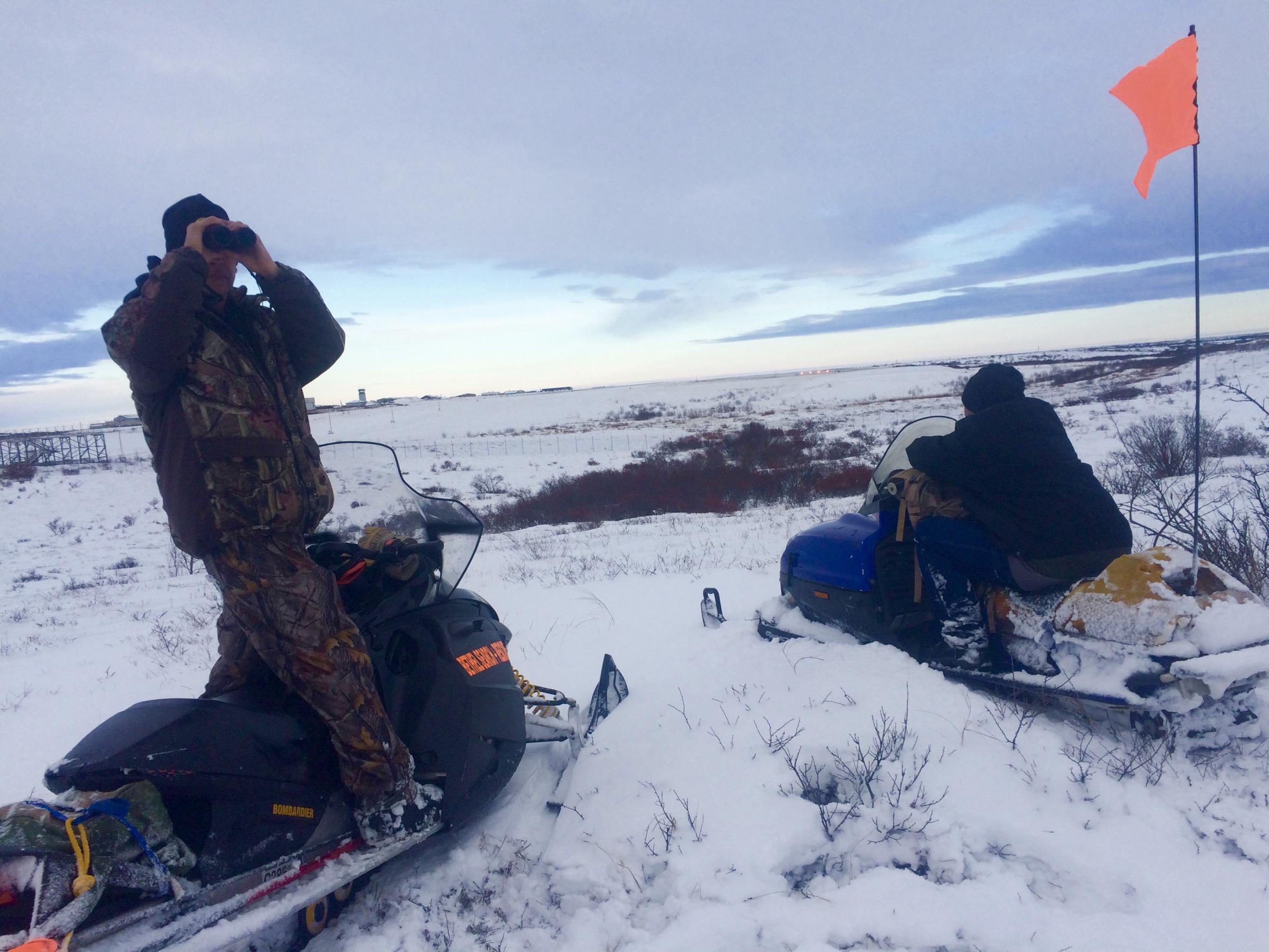 Bethel Search and Rescue members scan the tundra looking for signs of animals scavenging on November 28, 2017, hours before Robert Nick was found near the Bethel runway, which lies in the photo’s background. (Photo by Anna Rose MacArthur/KYUK)