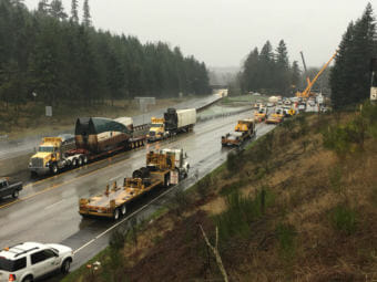 Heavy lift cranes have removed the two Amtrak rail cars that were dangling over the lanes of southbound I-5 from a railroad overpass in DuPont, Washington. (Photo by Tom Banse/Northwest News Network)