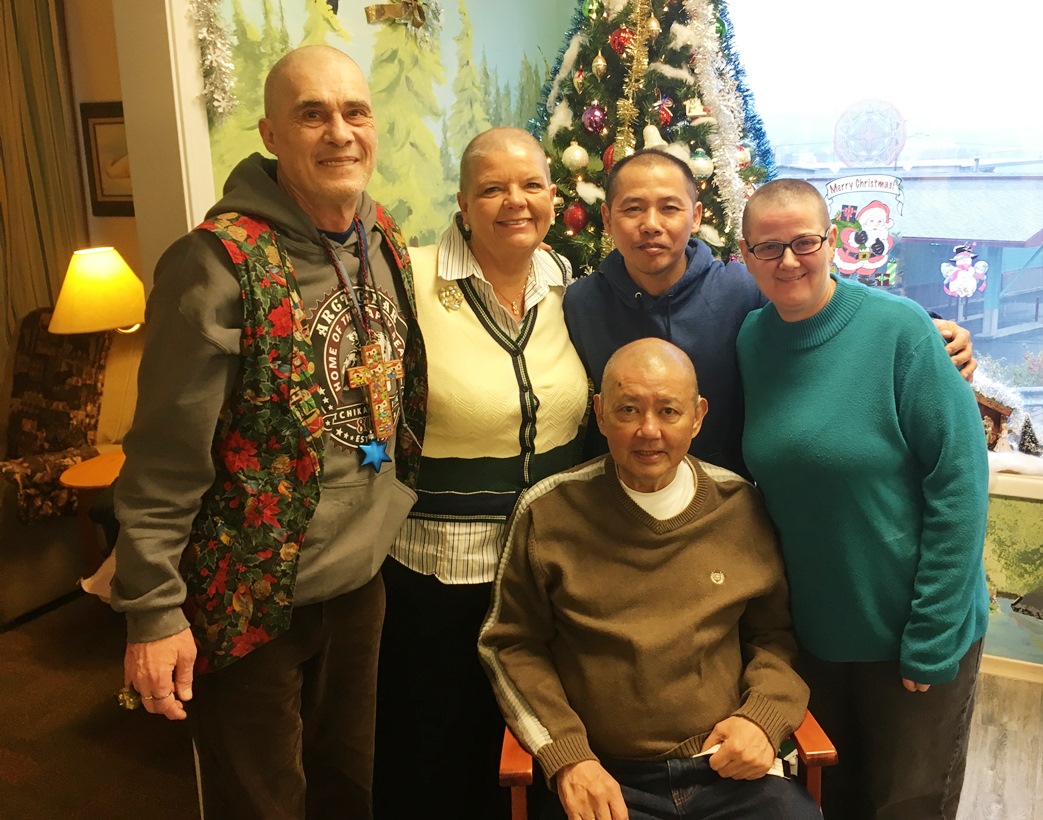 Don Harrington, left, Licha Kelley-King, Phong Nguyen, Kessinger and Virgil Panchle, seated, shaved their heads in support of Bobbi Kessinger. (Photo by Leila Kheiry/KRBD)
