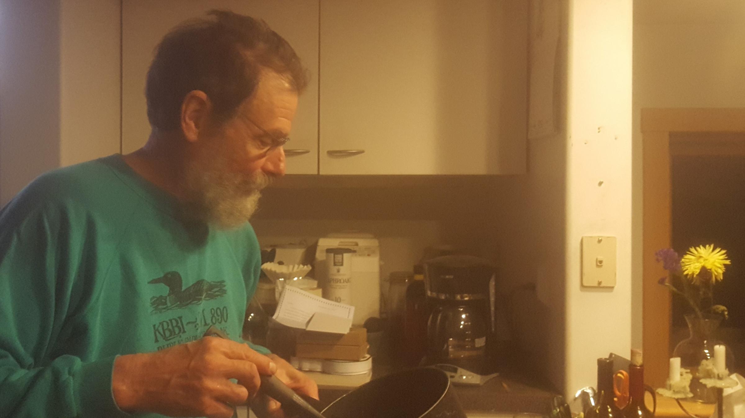 Barrett Fletcher stirs sauce for the Church of the Flying Spaghetti Monster meeting. (Photo by Renee Gross/KBBI)