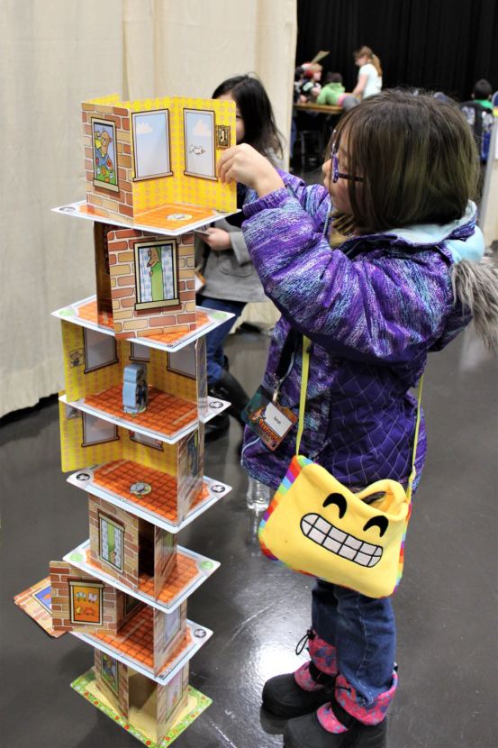 A child plays Rhino Hero at Platypus Con on Jan. 28, 2018. (Photo by Adelyn Baxter/KTOO)