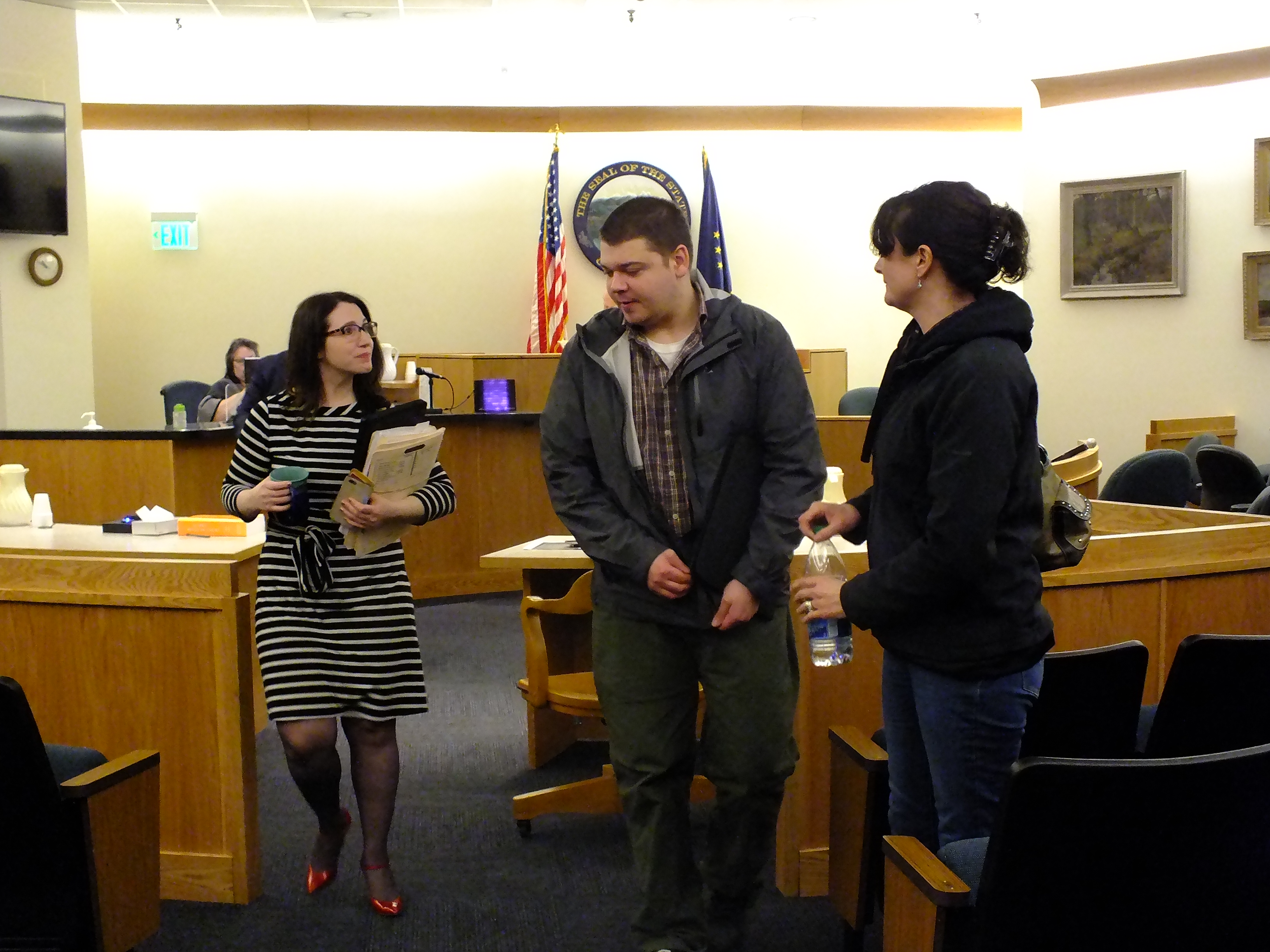 Assistant District Attorney Bailey Woolfstead, left, walks past Cecil Trent Yeisley and his aunt Monday, January 8, 2018, after Yeisley's sentencing before Judge Philip M. Pallenberg in Juneau Superior Court. Yeisley was sentenced to probation as part of a plea agreement. (Photo by Matt Miller/KTOO)