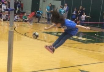 Mia Korn, 8, from McGrath, executes a 2-foot high kick at the Junior Native Youth Olympics on Feb. 24, 2018. (Photo by Johanna Eurich/KYUK)