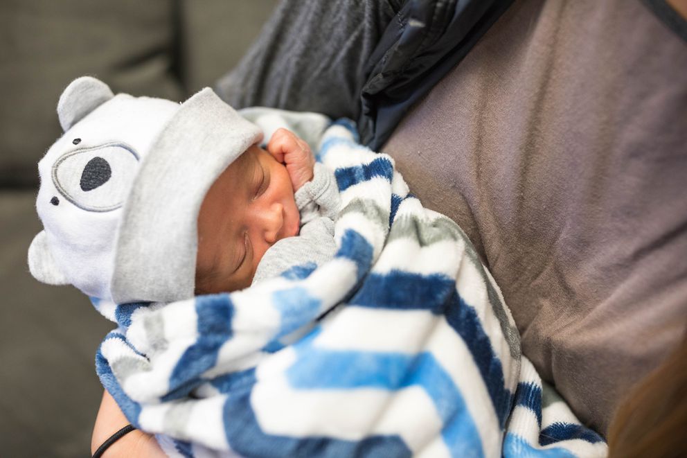 Hannah Johnson holds her son Kahleel at the McKinnell House on Tuesday. He was born on Jan. 24. (Photo by Loren Holmes/Anchorage Daily News)