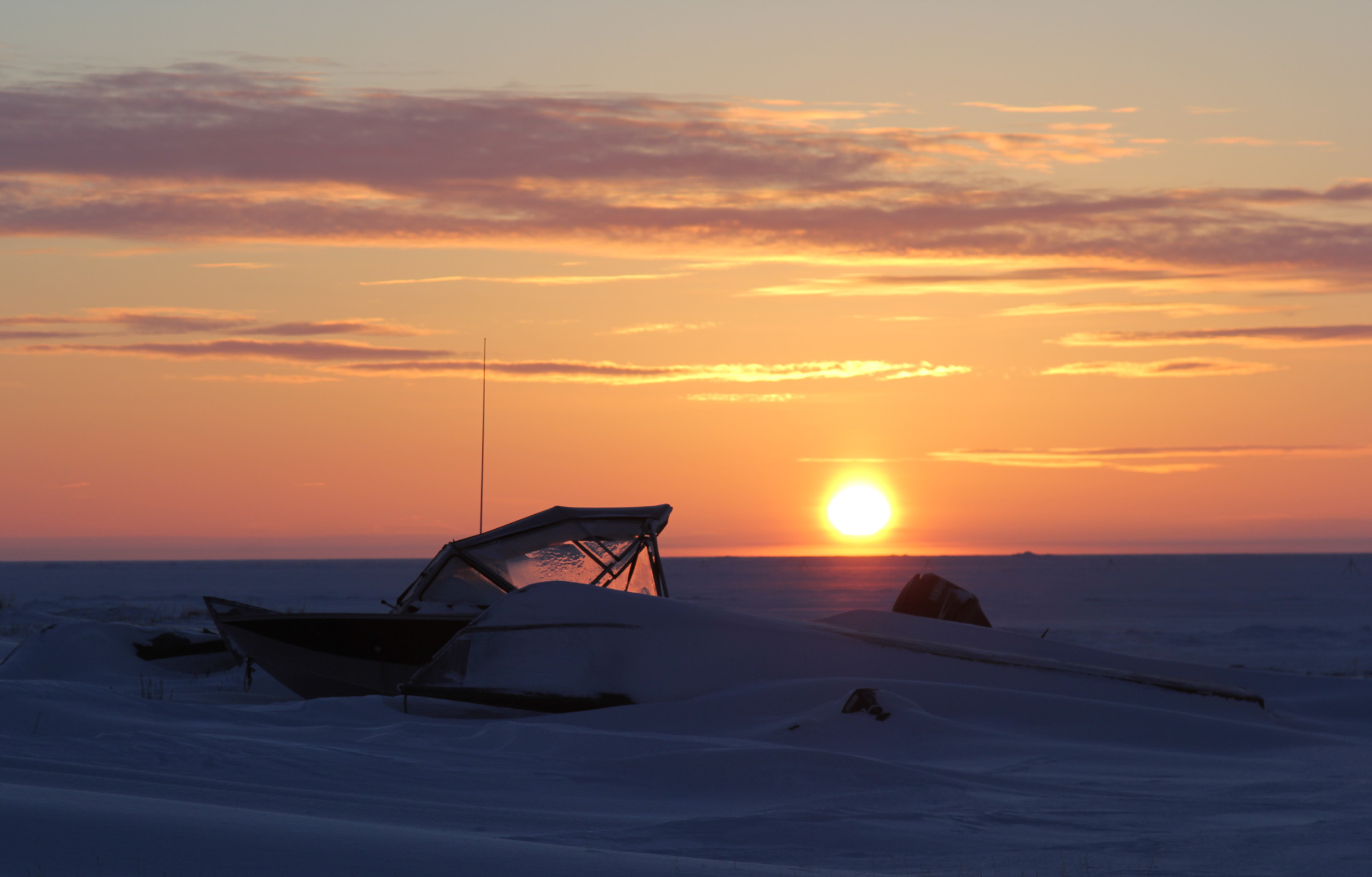 A boat buried under snow on the south side of Shishmaref near the lagoon (Photo by Zachariah Hughes/Alaska Public Media)