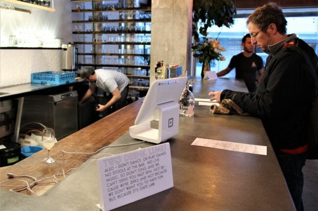 Amalga Distillery co-owner Brandon Howard mixes a drink for a customer on Saturday, Feb. 3, 2018. (Photo by Adelyn Baxter/KTOO)