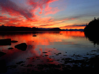 The sun set casts brilliant red light at Lena Beach in Juneau on July 31, 2017.