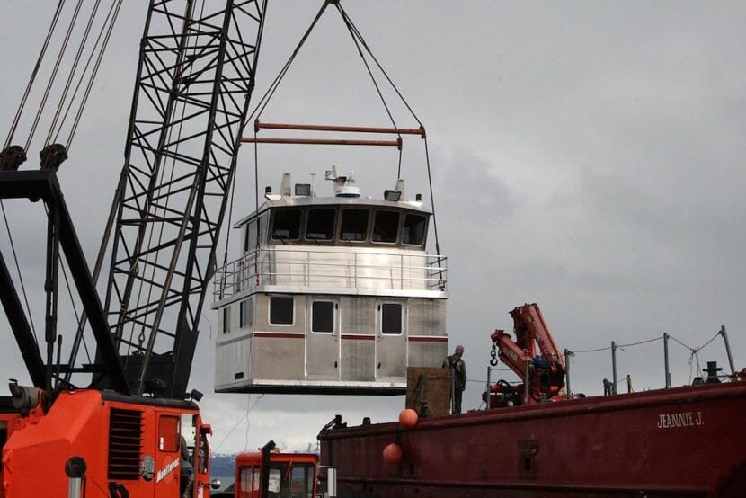 A crane moves an aluminum replacement cabin made by Homer's Bay Weld Boats. The company is one of a number of Alaska businesses already affected by President Trump's imported metals tariffs. (Photo courtesy Bay Weld Boats.)
