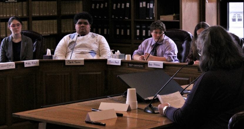 Juneau-Douglas High School students Molly Minick, Clark Toutai, Theo Houck and Katie McKenna listen as a community member testifies at a meeting about whether to keep the district's Thunder Bear mascot on Saturday, March 10, 2018. (Photo by Adelyn Baxter/KTOO)