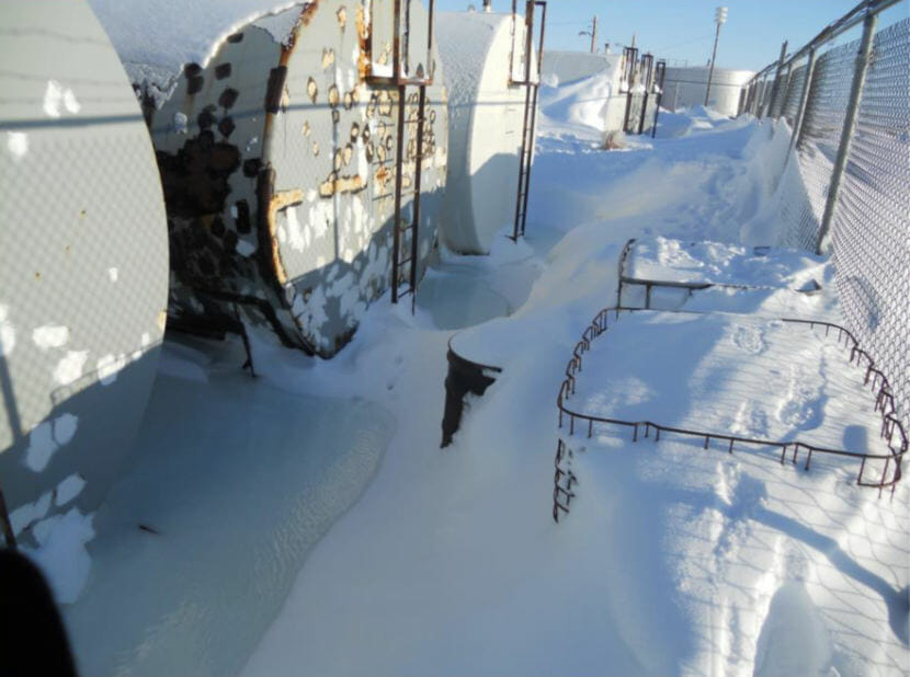 Several tanks stand in pools of heating oil that was spilled during a tank transfer at the Savoonga Native Store in Savoonga, Alaska. (Photo courtesy/Savoonga Native Store)