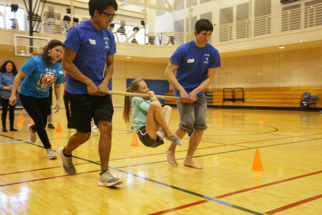 Rayna Tuckwood, 11, competes in the Wrist Carry event at the 2018 Traditional Games. Her distance of 186 feet 4-and-a-half inches won the female Middle School Division. The contest was sponsored by Sealaska Heritage, Central Council of Tlingit and Haida Indian Tribes of Alaska and Wooch.Een in collaboration with Goldbelt Heritage. (Photo by Annie Bartholomew/KTOO)
