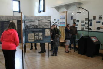 Visitors read up on the SS Princess Sophia at a new exhibit in Skagway, which had its grand opening on May 7, 2018.