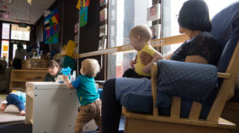 Child care workers interact with infants at Gold Creek Child Development Center in Juneau on May 11, 2018. State rules require certain square footage and staffing levels, which limit this center's infant care capacity to 10. New state rules being proposed may force that capacity down to 8.