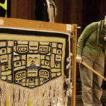 Dorica Jackson talks about a robe she spent almost 15 years working on during a weavers' presentation Wednesday, June 6, 2018, at the Shuka Hit clan house in the Walter Soboleff Building in downtown Juneau.