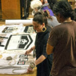 Meghann O'Brien talks about her pieces during a break from the weavers' presentation Wednesday, June 6, 2018, at the Walter Soboleff Building.