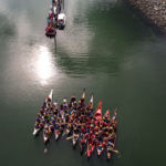 Paddlers aboard canoes request permission to come ashore in Douglas Harbor on June 5, 2018.