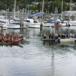 A group of canoes wait for permission from Native elders to land in Douglas Harbor on Tuesday, June 5, 2018.