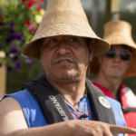Doug Chilton talks with people at Douglas Harbor after the canoes landed for Celebration on June 5, 2018.
