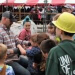 Dominic Hoy, an employee of Coeur Mining, demonstrates setting chokers for competitors in the children's choker setter race at Gold Rush Days on Sunday, June 17, 2018.