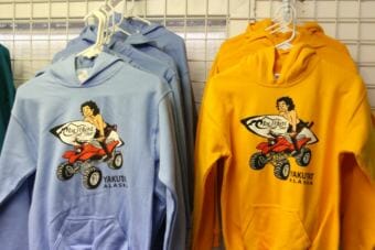 Since 1999, Icy Waves Surf Shop has outfitted the surfers of Yakutat with wet suits and boards. The unlikely location has attracted big wave surfers and surf enthusiasts to the community of 600. Many come away with a T-shirt. (Photo by Emily Kwong/KCAW)