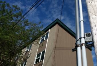 A digital camera is attached to a utility pole on June 13, 2018, overlooking the crosswalk at Seventh and Gold streets in downtown Juneau. The camera was installed to deter people from painting a crosswalk in rainbow colors.