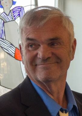 Don Etheridge smiles as Cathy Muñoz introduces him as a candidate for Alaska's Senate District Q at a campaign event at Rie Muñoz Gallery in Juneau on July 12, 2018.