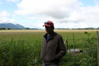 Frank Rue stands in his backyard. The Mendenhall Wetlands State Game Refuge was established in 1976. (Photo by Elizabeth Jenkins/Alaska's Energy Desk)
