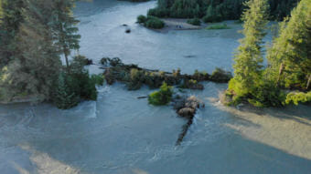 Water flows through a new gap in the oxbow on the Mendenhall River on July 19, 2018.