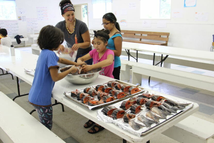 Mique'l Dangeli teaches students how to bake salmon fins. Dangeli moved to British Columbia to teach Tsimshian culture in her ancestors' traditional territory, but faces an immigration fight to live and work in Canada. (Photo courtesy Mique'l Dangeli)