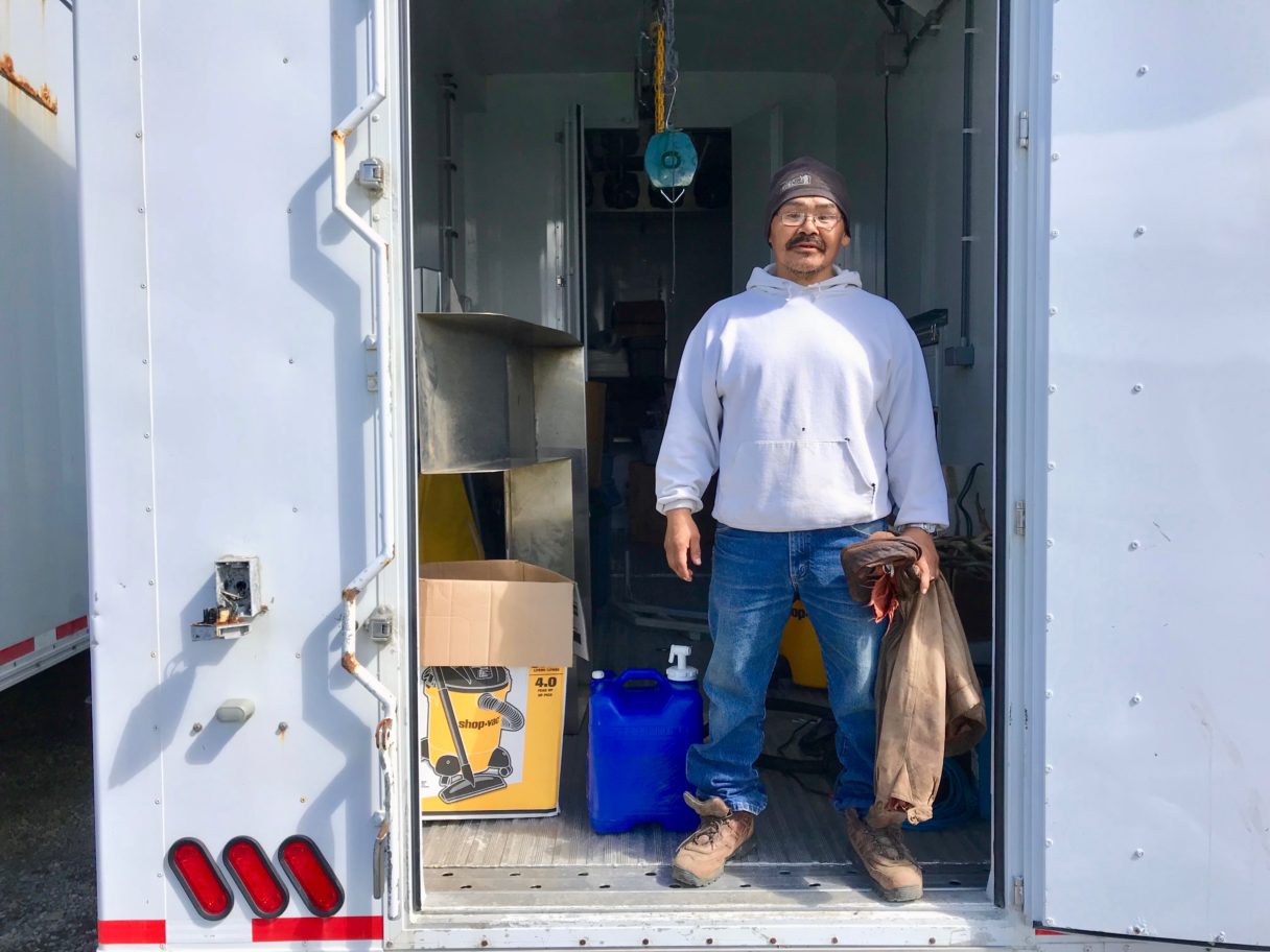 Savoonga’s chief reindeer herder Richmond Toolie, at the mobile reindeer processing plant (Photo by Gabe Colombo/KNOM)