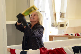 Alaska first lady Donna Walker breaks a champagne bottle on the hull of the new state ferry Tazlina in Ketchikan on Aug. 11, 2018.
