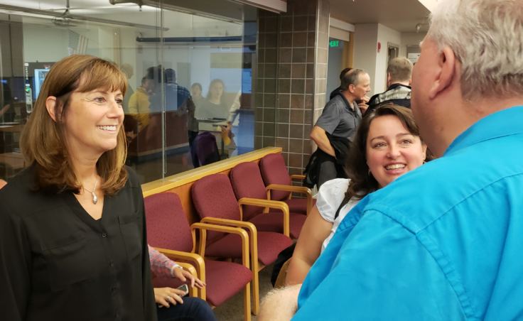 Juneau School Board member Emil Mackey congratulates Bridget Weiss for being selected interim superintendent of the Juneau School District on Monday, Aug. 6, 2018.