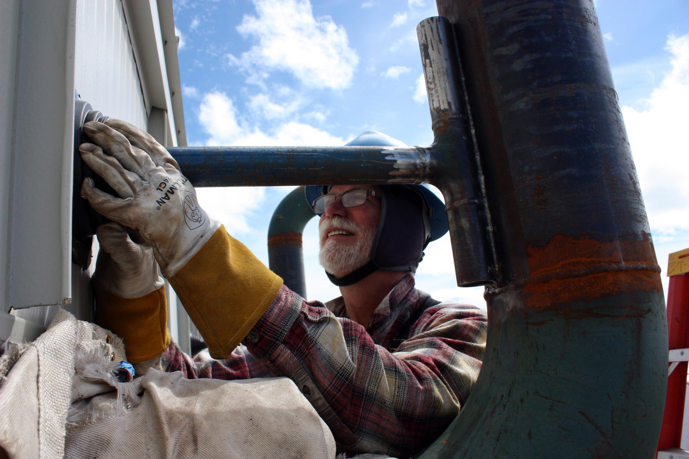 Carl Hefty works on Aug. 3on Togiak's new power plant. The four new diesel generators should be supplying the village with power by mid-September. (Photo by Austin Fast/KDLG)