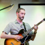 Alex Nelson of Juneau performs with Amish Robots, now known as Revilla, at the KXLL Showcase during the 2018 Alaska Folk Festival at the Hangar Ballroom. (Photo by Annie Bartholomew/KTOO)