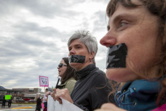 Cheryl Fellman, left, and Kristin Cox, silently protest outside of U.S. Sen. Lisa Murkowski's office in Juneau against the confirmation of Brett Kavanaugh to the U.S. Supreme Court on Sept. 28, 2018.