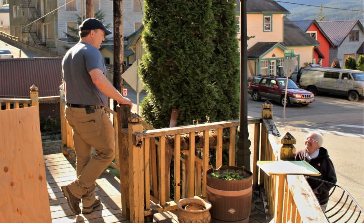 Dave D'Amato, who makes legal decisions for Camilla Barrett, talks to a neighbor outside 401 Harris St. in Juneau on Oct. 1, 2018.