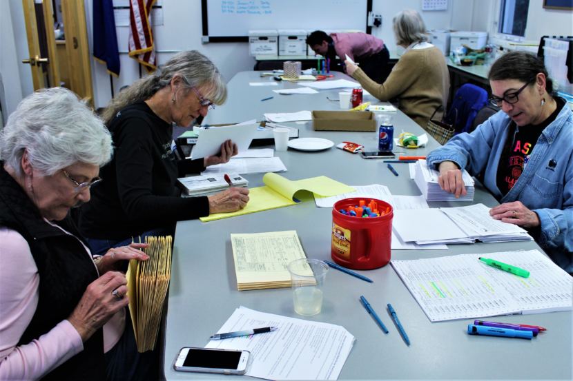 Canvass Review Board members Betty Cook, Carol Schriver and Tami Burgett count absentee ballots from the Oct. 2 municipal election at City Hall on Oct. 5, 2018. (Photo by Adelyn Baxter/KTOO)