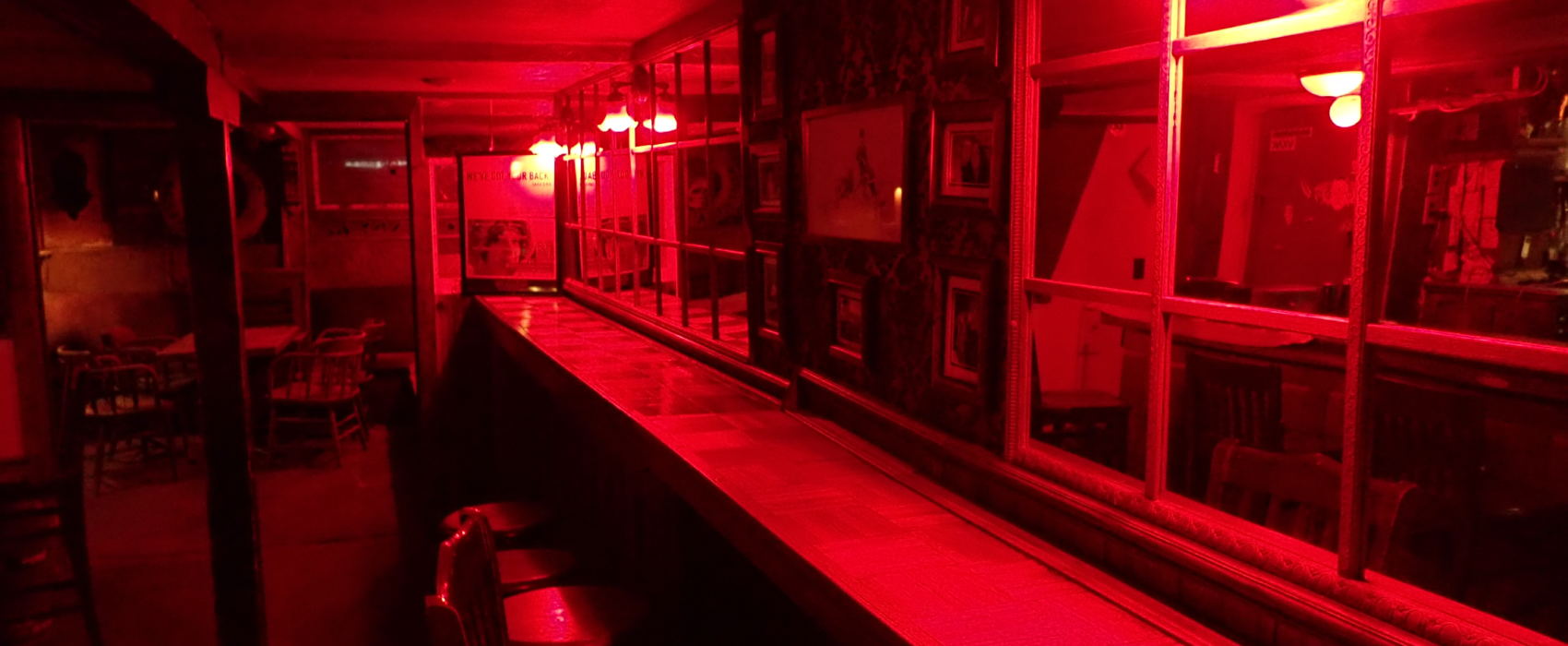 One never feels like they're drinking alone in the Alaskan Hotel's eerily-lit back bar. (Photo by Jacob Resneck/CoastAlaska)