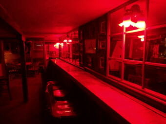 One never feels like they're drinking alone in the Alaskan Hotel's eerily-lit back bar. (Photo by Jacob Resneck/CoastAlaska)